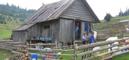 Shepherd family in their wooden home. 