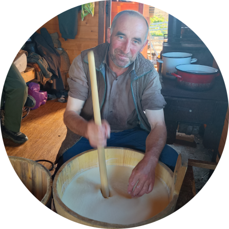 A shephed making cheese.