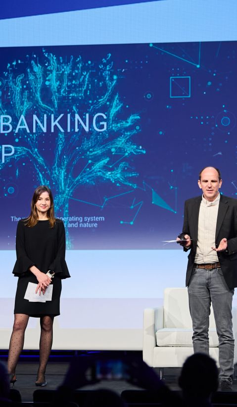 Two speakers on stage giving presentation