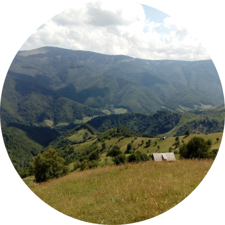 Beautiful mountainous landscapes, dotted with a few buildings. 